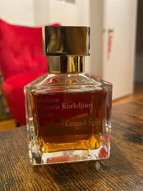 Maison Francis Kurkdjian Perfume Bottle with Gold Cap and Amber Liquid